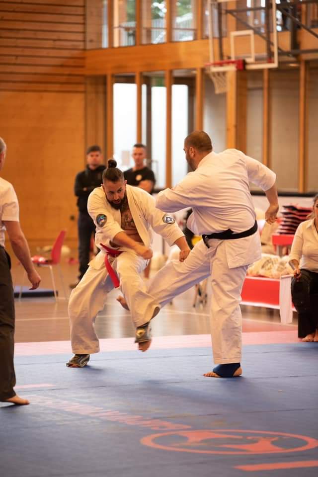 Kyokushin karate Instructor Kleomenis in competition performing gedan mawashi geri