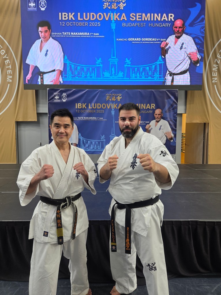 black belt instructor posing in a fighting stance with Shihan Tats Nakamura (7th Dan) at the IBK Ludovika Seminar.